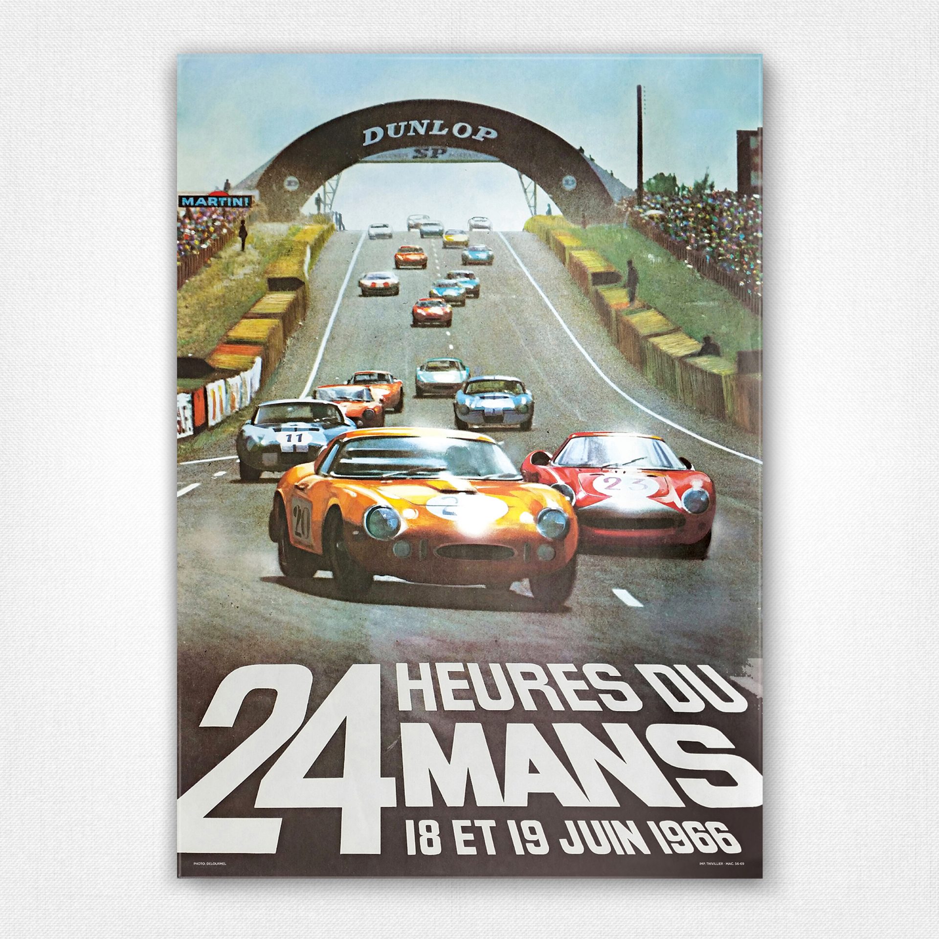 A vintage looking magazine front of race cars 